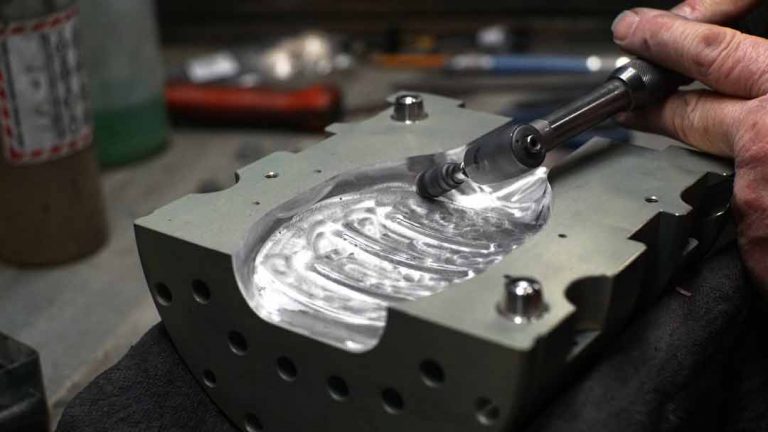 Close up view of an Injection Stretch Blow mold being polished.